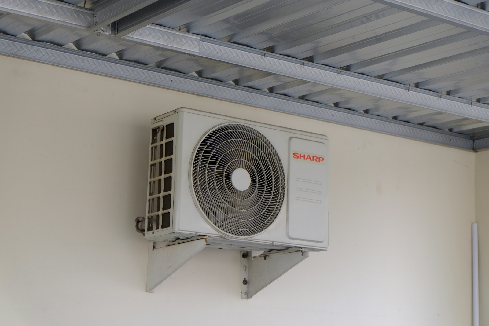 Professional air conditioning condenser unit installed on exterior wall