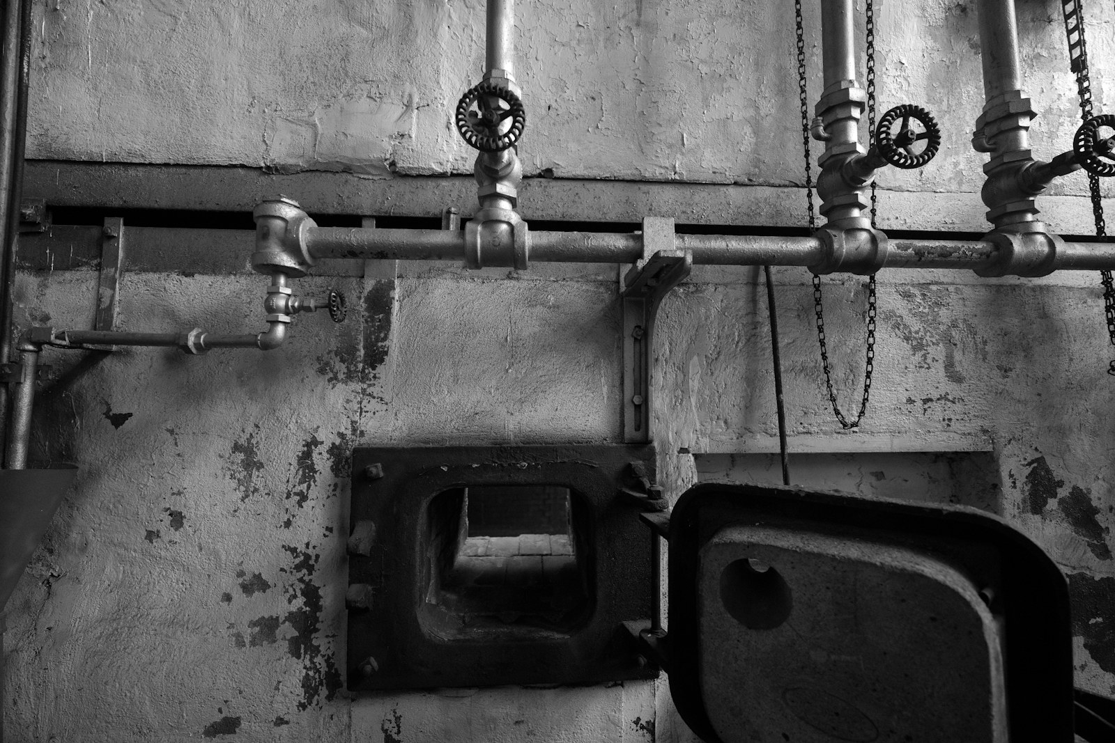 Industrial boiler room with pipes, valves, and furnace equipment