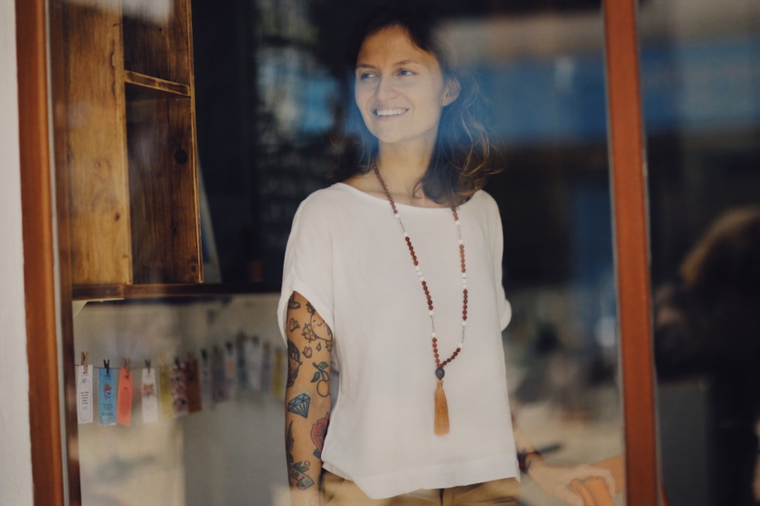a woman standing in front of a store window