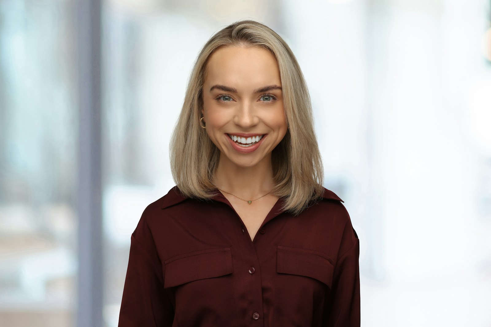 Smiling professional woman in a maroon shirt