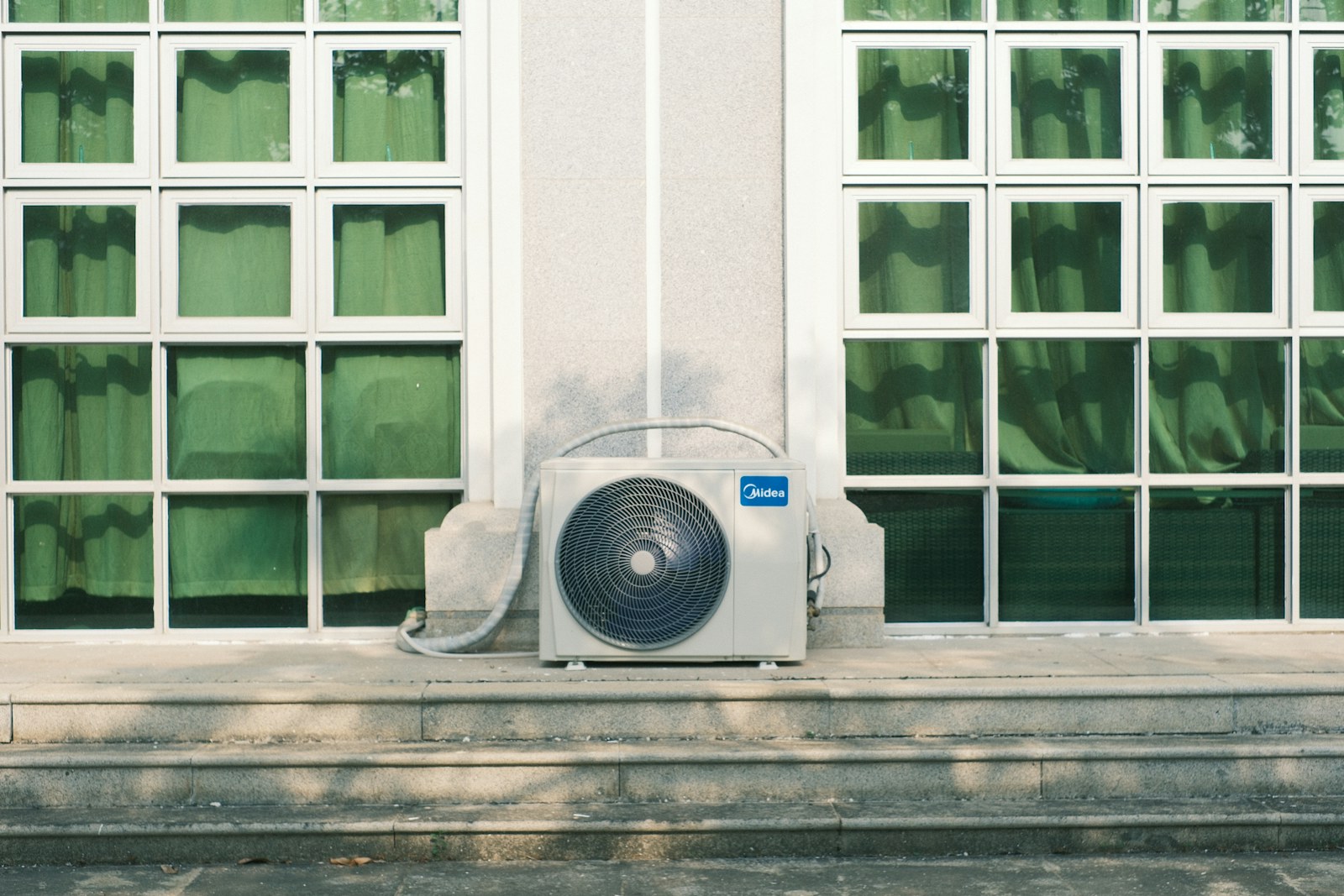 Professional AC condenser unit installed on building exterior